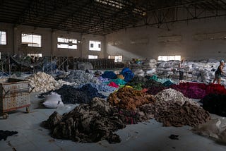 Sorting through hundreds of tons of clothing in an abandoned factory for a social mission called Clothing the Loop.