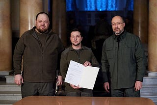 Image of Ukrainian president Volodymyr Zelensky, together with Prime Minister, Denys Shmyhal, and Parliament Speaker, Ruslan Stefanchuk, with Zelensky holding the signed application for EU’s candidate status to Ukraine.
