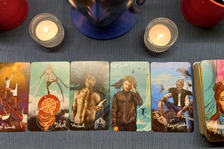 A tarot spread of five cards along with the bottom deck energy. Candles lit to clear the space of negativity and bring in clarity.