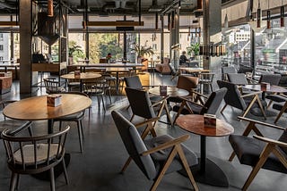 Image of a café room filled with tables and chairs