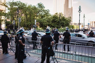 Stock photo of geared up policemen behind a barricade.