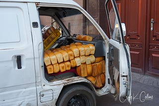 A white van is stuffed with hundreds of loaves of fresh-baked bread.