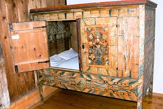 An ancient wooden sleeping cabinet.