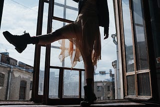 A woman’s profile, dancing in the window