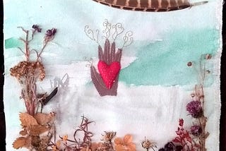 A multimedia artwork: watercolour on canvas, appliqued plants, a feather, and a fabric hand and heart with gold threads.