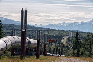 A pipeline cutting through trees and mountains