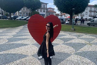 Monção — Portugal — Red Heart with a Smiling Girl in a black dress