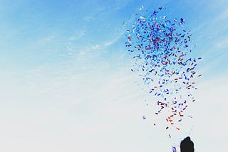 A photo of a woman releasing confetti