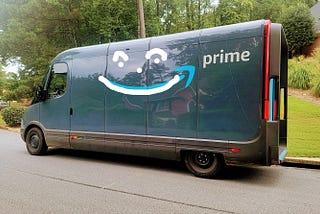 Image of Amazon Prime delivery truck with a smiley face drawn over it.
