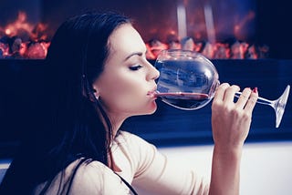 French woman drinking a glass of red wine