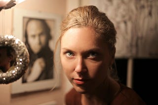 A portrait of a woman with a probing expression.