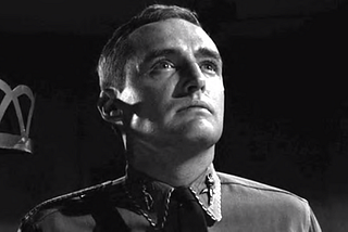 Dennis Hopper as Petr Vollmer in uniform, staring skyward
