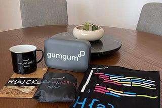 Image of this year’s swag including a mug, beeswax wrapper, t-shirt, reusable shopping bag, and reusable container.