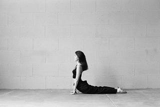 A young girl stretching in cobra pose.