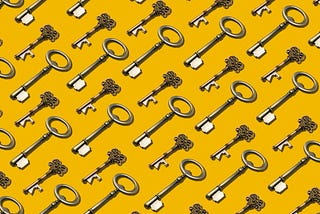 A bunch of old keys against a bright yellow background