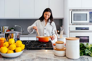 a woman cooking inside a kitchen