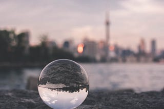 A lens bubble reflecting a city to show an introvert point of view