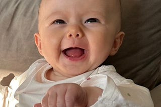 smiling two month old baby