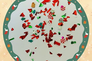 A collection of Christmas glitter and motifs on a plate with a Christmas border.