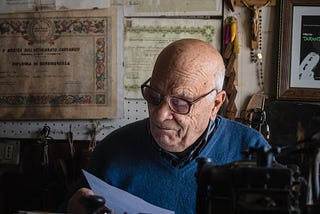 An old guy reading a paper