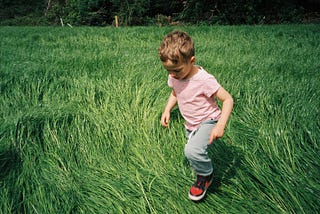 Emmet Abrussezze, 5, of County Wexford, Ireland, runs through the field in Rathnure, Ireland, on…