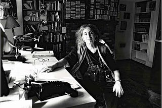 The radical feminist author Andrea Dworkin seated at her desk in her booklined study in Brooklyn, October 2003.