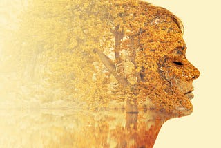 Female face with trees and leaves coming out of her head.