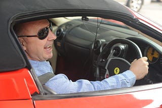 man in a ferarri car