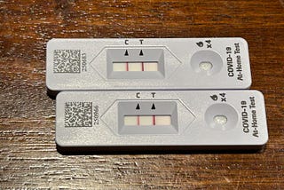 Two covid-19 at home tests showing a positive result.