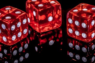 three red colored die with white dots