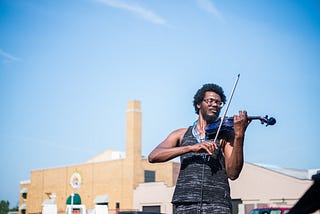 Violinist Christopher James plays at the Toledo Farmer’s Market.