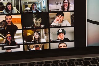 A community of creators in a virtual meeting. You see 9 boxes with individual faces on a laptop screen.