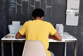 A person sitting at a desk studying.