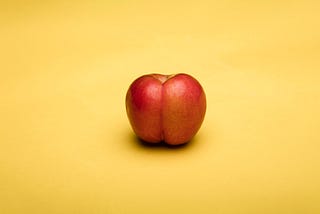 Metaphorically loaded image of a peach that looks like a human butt