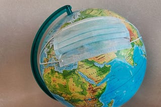 A globe “wearing” a face mask against covid19