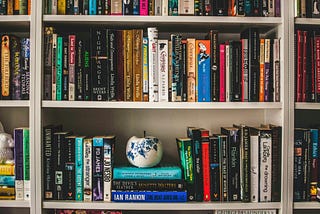 Bookshelves full of books, mostly novels
