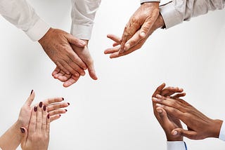 Business people clapping hands together