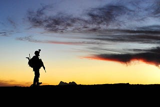 A silhouette of a soldier paying tribute