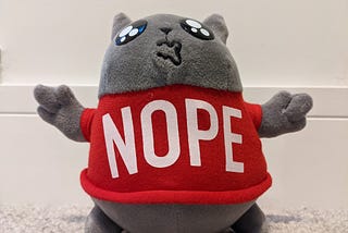 A cuddly toy with a Nope jumper