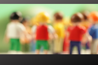 A blurred picture of Lego children of different colors — Picture by super snapper -on unsplash
