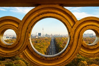 road leading to the city of Berlin Germany seen through a concrete filigreed railing.