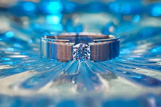 Diamond ring, blue diamonds on table