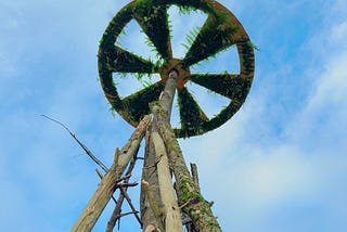 A large ceremonial bonfire with a wheel on top.