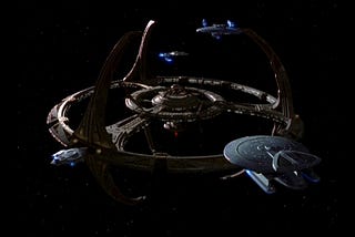 The Deep Space Nine space station with several Federation starships docked.