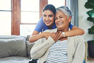 home health aide hugging her client