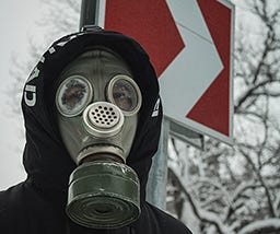 Guy in gas mask and hoodie