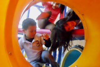 My son in play structure with two girls at McDonald’s.