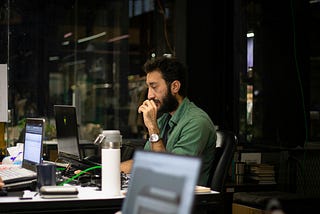 A guy working and looking very confused.