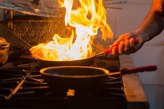 Flaming saute pan in an industrial kitchen