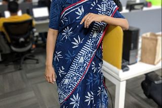 Photo of the author in a saree at her workplace.